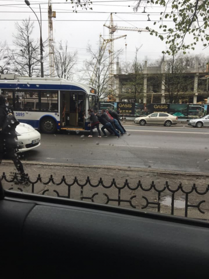 Momentul in care un troleibuz este impins de taxator si pasageri pentru a se putea conecta la reteaua de curent: „Mai multe masini parcate neregulamentar au creat obstacol” - FOTO