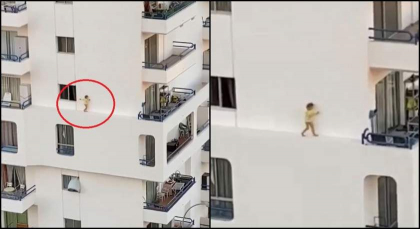 Imagini de infarct. O fetita merge pe bordura ingusta a fatadei unei cladiri, in timp ce parintii fac dus - VIDEO Imagini de infarct. O fetita merge pe bordura ingusta a fatadei unei cladiri, in timp ce parintii fac dus - VIDEO