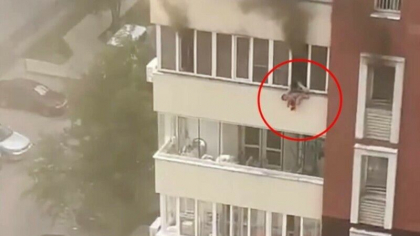 Momentul in care un copil este aruncat pe geam de mama sa, dupa ce apartamentul in care locuiau a fost cuprins de flacari - VIDEO
