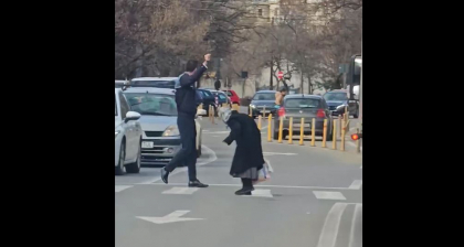 Gest viral. Un politist roman a coborat din masina, in timpul examenului auto, pentru a ajuta o batranica sa traverseze strada - VIDEO