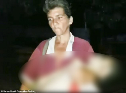 Imagini dramatice in Venezuela. O mama merge pe strazi cu fiica sa moarta in brate - FOTO