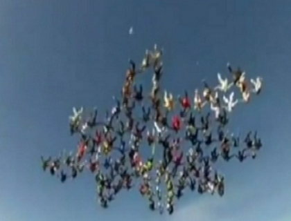 Au doborat un record mondial. Peste 100 de parasutisti s-au aranjat in aer in forma unui fulg de nea